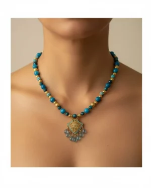 women wearing Blue Apatite Moroccan Pendant Necklace Deep ocean blues and turquoise tones meet golden detailing in this Moroccan-inspired statement piece - finished with a decorative pendant that catches the light with every movement.